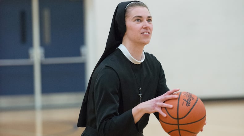 Sister Mary Xavier, showing her old Ohio State and Anna High form, getting ready to launch a shot when she spoke to a group of over 700 people at the Russia High gym in the summer of 2018. Before the convent, when she was Sarah Schulze, she scored 1,569 points and grabbed 880 rebounds in her Anna High career and then played 111 games for the Buckeyes and was the team captain as a senior. Photo courtesy of Nicole Voisard/Simply Nicole Photography