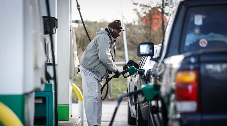 Stan Terrell, from Dayton, pumps $2.79 a gallon gas at the BP on Edwin C. Moses Boulevard Tuesday, Dec. 3, 2024. The national average for a gallon of gas fell below $3 Monday afternoon for the first time since May 2021. JIM NOELKER/STAFF