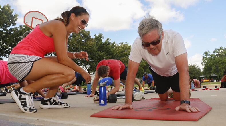 Instructor Stacy Buky laughs at Dan Short, 72, comments as she checks on his progress at a Camp Gladiator boot camp workout in Fort Worth Wednesday June 28, 2017. Mr. Short loves to make his fellow gladiators laugh. (Ron Baselice/Dallas Morning News/TNS)