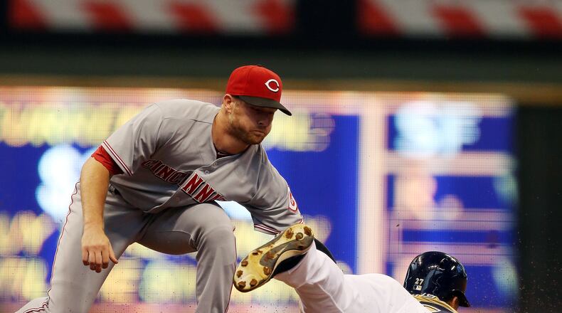 MILWAUKEE, WI - SEPTEMBER 15: Zack Court # 2 of the Cincinnati Reds tags out Carlos Gomez #27 of the Milwaukee Brewers at Miller Park on September 15, 2013 in Milwaukee, Wisconsin (Photo by Tasos Katopodis/Getty Images)