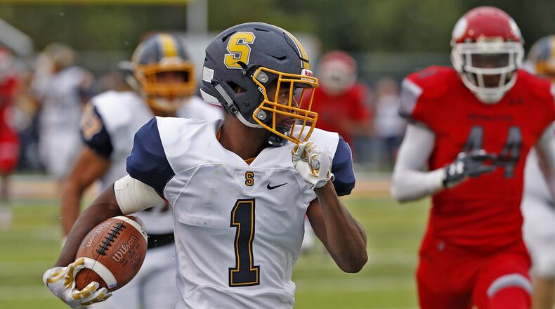 Springfield’s Caleb Johnson runs down the side line for a big gain after catching a pass against Princeton during Friday’s game. BILL LACKEY / STAFF