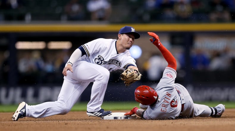 MILWAUKEE, WISCONSIN - MAY 21:  Phillip Ervin #6 of the Cincinnati Reds slides into second base for a double past Keston Hiura #18 of the Milwaukee Brewers in the first inning at Miller Park on May 21, 2019 in Milwaukee, Wisconsin. (Photo by Dylan Buell/Getty Images)