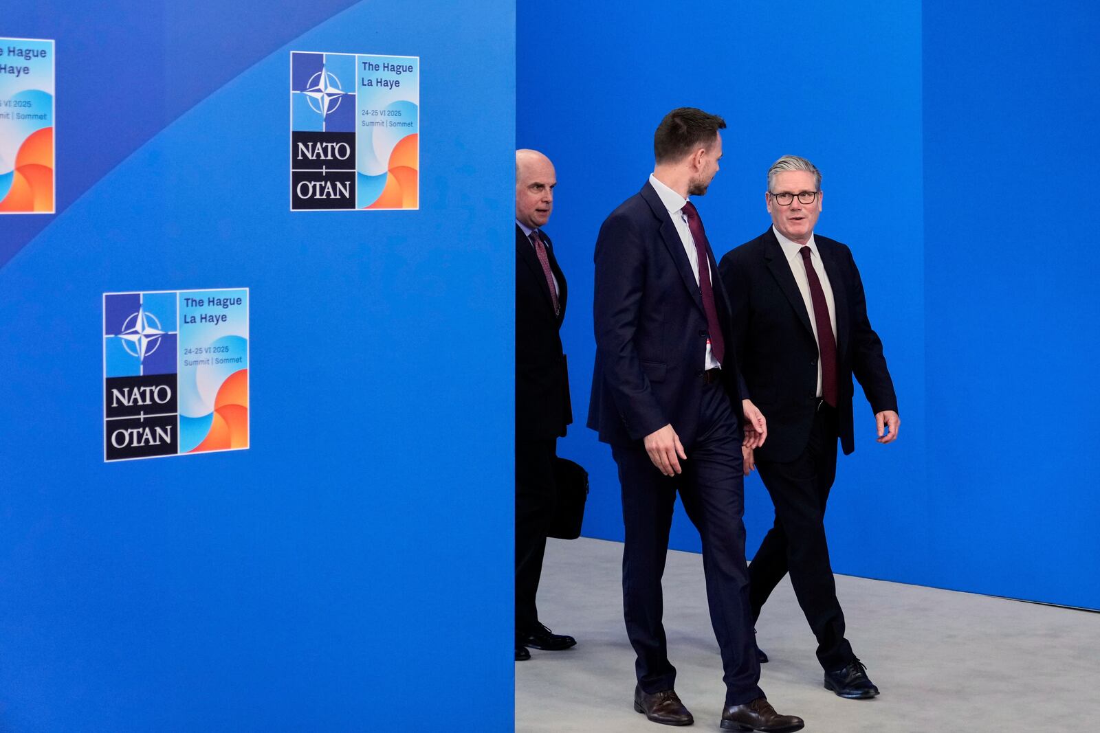 Britain's Prime Minister Keir Starmer, right, arrives for the NATO summit in The Hague, Netherlands, Wednesday, June 25, 2025. (AP Photo/Matthias Schrader)