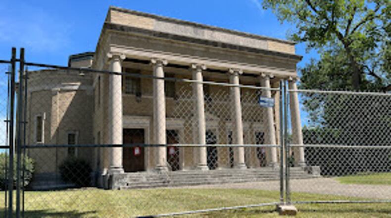Fencing was being placed around the former First Church of Christ, Scientist, in the South Dayton Rubicon residential neighborhood near the University of Dayton campus Tuesday. Dayton has issued a wrecking permit for the site. THOMAS GNAU/STAFF