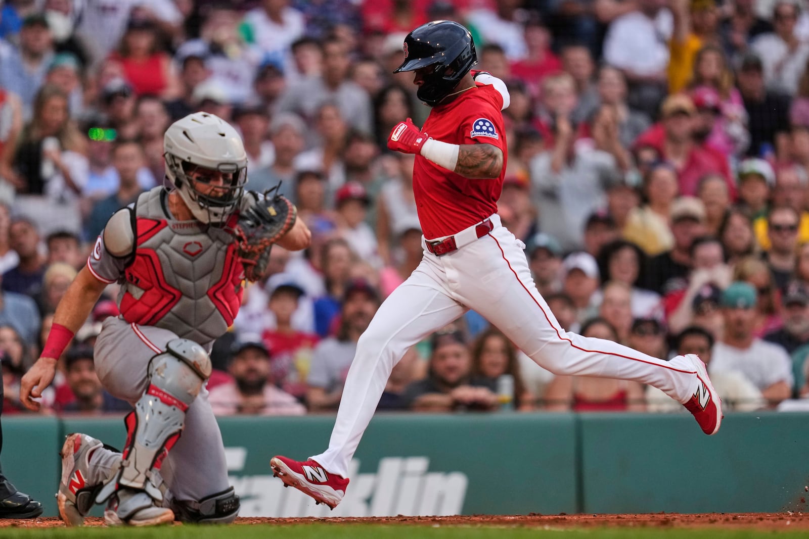Boston Red Sox's Ceddanne Rafaela scores on a sacrifice by Romy Gonzalez against the Cincinnati Reds during the second inning of a baseball game at Fenway Park, Wednesday, July 2, 2025, in Boston. (AP Photo/Charles Krupa)