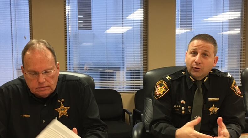 Bruce Langos, left, director of the Montgomery County Criminal Intelligence Center, and Rob Streck, the sheriff department’s chief deputy, argue that the center is making a difference across the region. THOMAS GNAU/STAFF