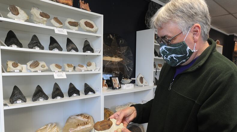Eric Clark, owner of Rock Around the Clark, in Yellow Springs, talks about one of the many items he has in his store. MARSHALL GORBY\STAFF