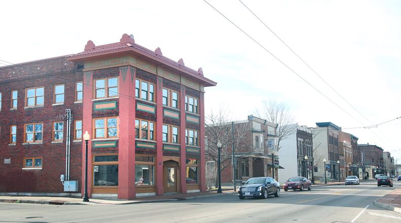 A three-story building at 1000 W. Third St. (left) is among two recent real estate sales raising hopes this area of Dayton could offer more amenities and buoy new investment. LISA POWELL / STAFF