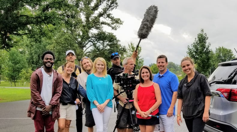 Indian Lake realtor Paige Duff (blue shirt) is pictured with Dayton area residents Chris and Tina Gibbs (second and third from right) and members the crew of HGTV's "Island Life."