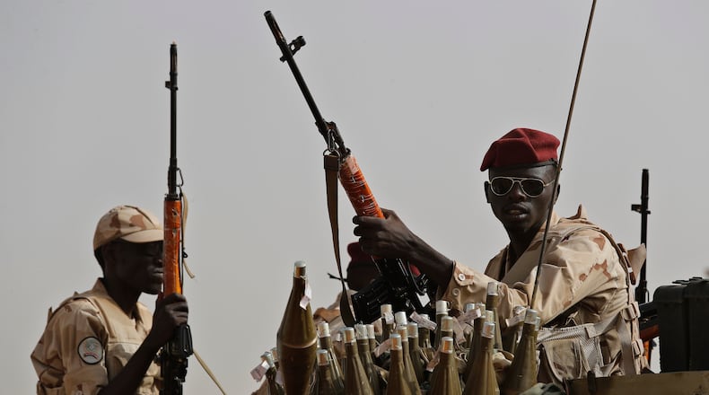 FILE - Sudanese soldiers from the Rapid Support Forces unit, led by Gen. Mohammed Hamdan Dagalo, the deputy head of the military council, secure the area where Dagalo attends a military-backed tribe's rally, in the East Nile province, Sudan, June 22, 2019. (AP Photo/Hussein Malla, File)