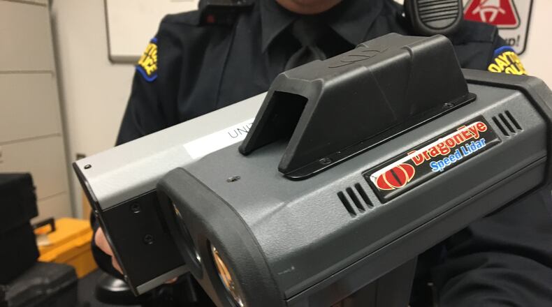 Dayton police Detective Jason Ward holds one of the new lidar laser photo devices. CORNELIUS FROLIK / STAFF