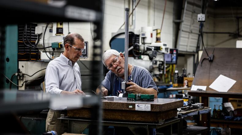 Jim Bowman, Noble Tool President and CEO, left works with tool maker and machinist, John Maxwell at the plant on Stanley Ave. in Dayton Friday Oct. 1, 2021. Bowman said he has less then 100 employees and he will not mandate the COVID-19 vaccine. JIM NOELKER/STAFF