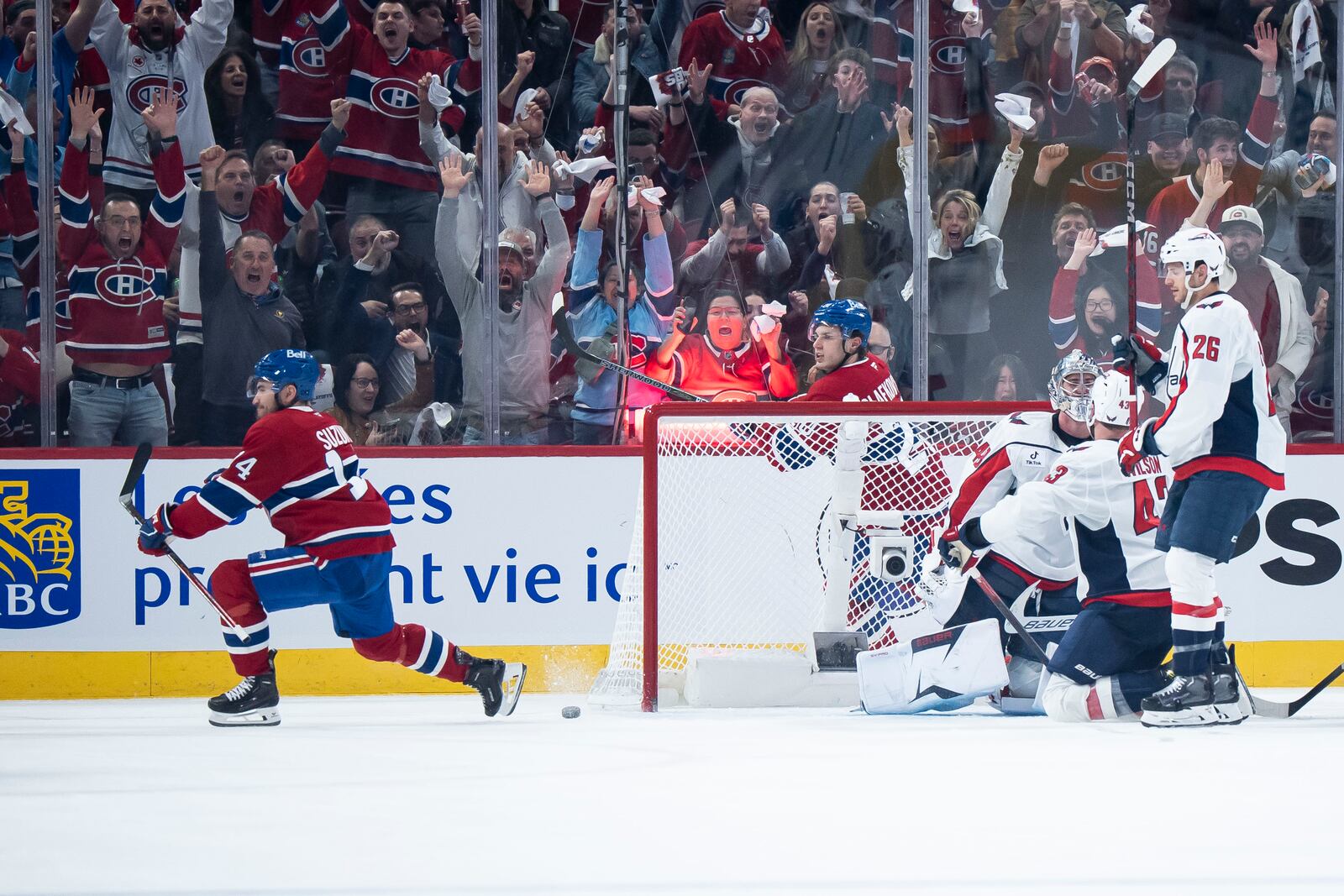 Montreal Canadiens' Nick Suzuki (14) scores against Washington Capitals goaltender Logan Thompson (48) during the second period of Game 3 of a first-round NHL hockey playoff series in Montreal Friday, April 25, 2025. (Christopher Katsarov/The Canadian Press via AP)