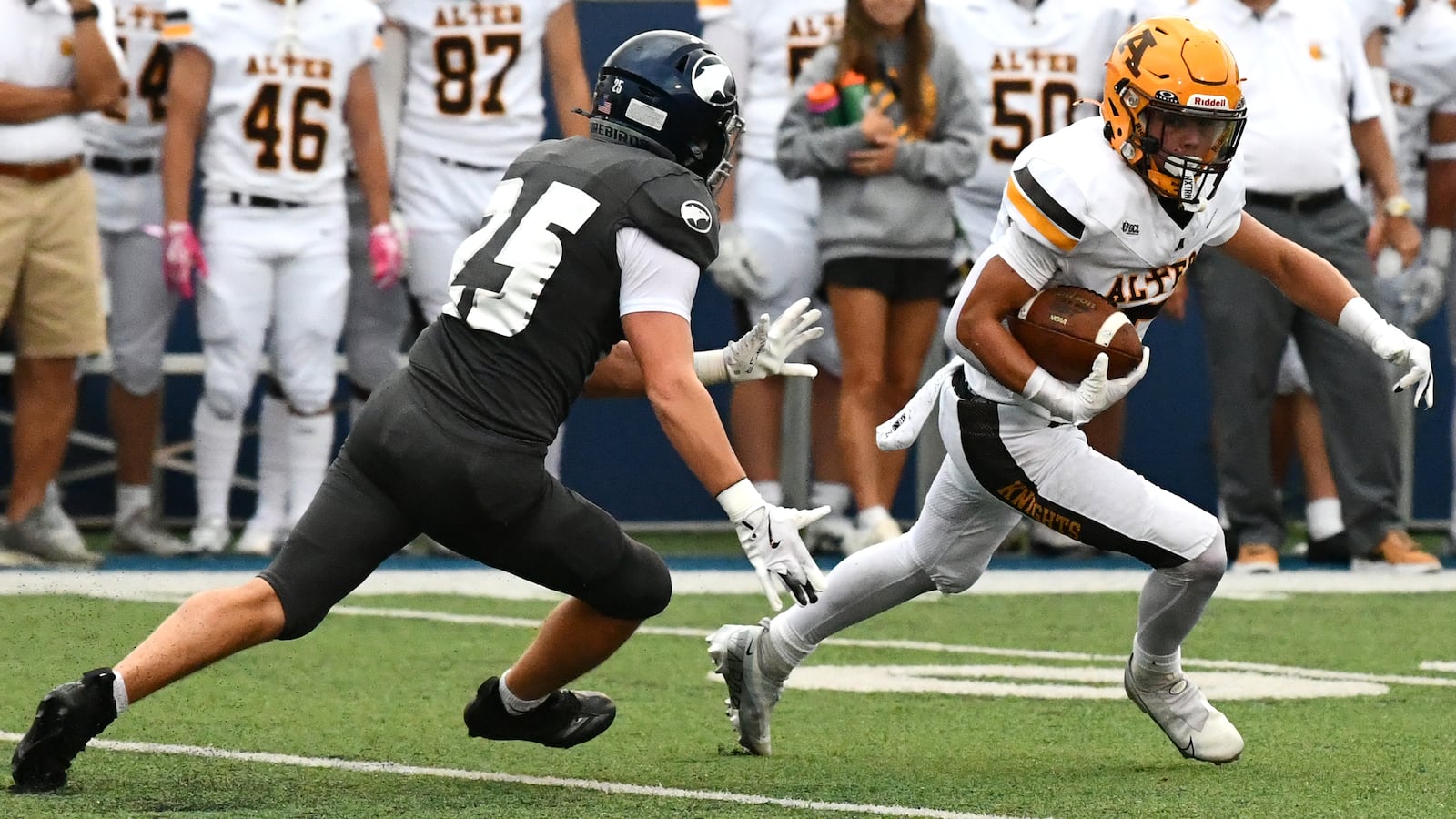 Alter's Drew Cripps tries to avoid Fairmont's Chase Ford during Thursday night's game at Roush Stadium. JEFF GILBERT/CONTRIBUTED
