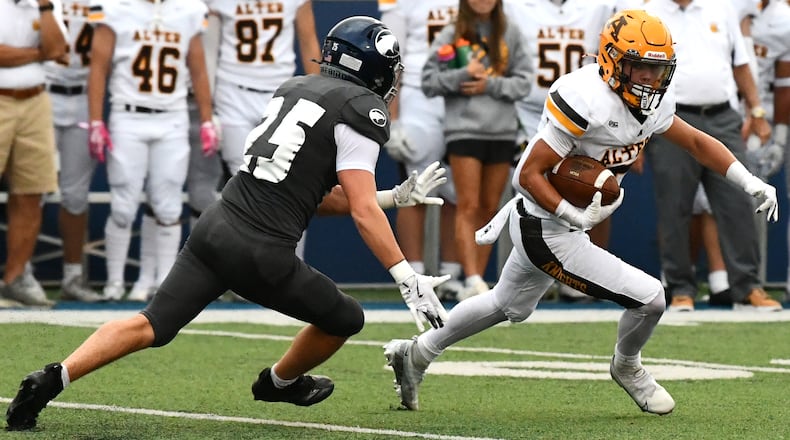 Alter's Drew Cripps tries to avoid Fairmont's Chase Ford during Thursday night's game at Roush Stadium. JEFF GILBERT/CONTRIBUTED