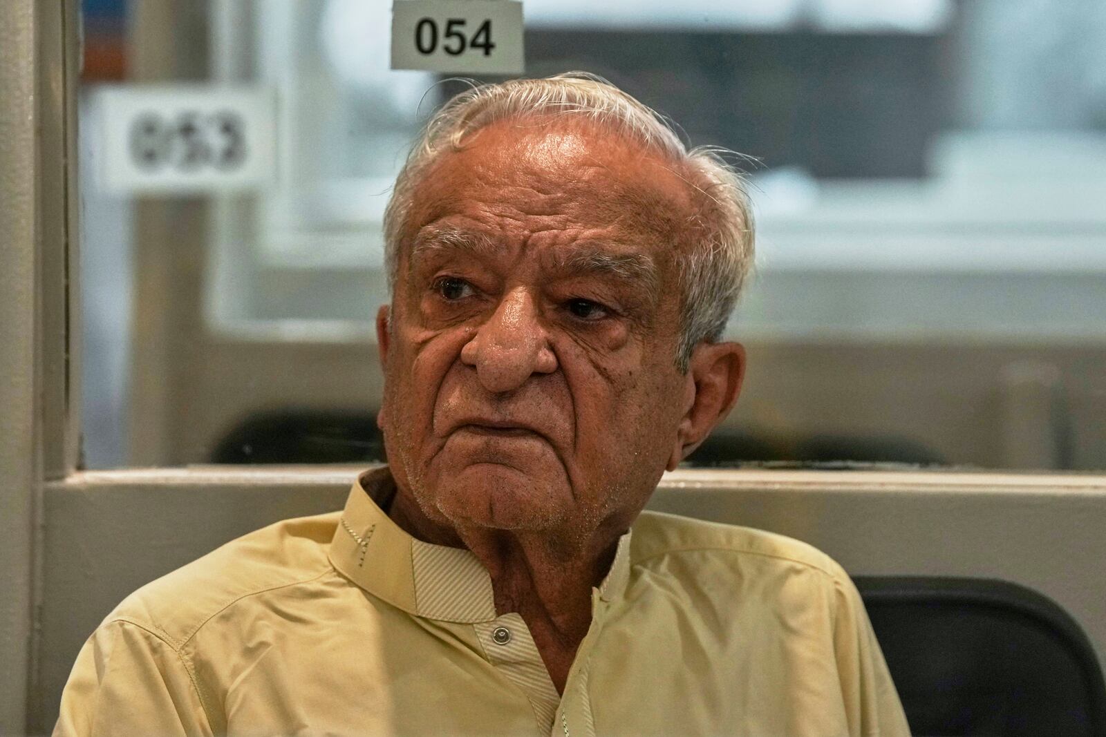 A dejected investor waits to restart trading, which suspended for an hour following a 5% drop in in its main index at the Pakistan Stock Exchange (PSE), in Karachi, Pakistan, Monday, April 7, 2025. (AP Photo/Fareed Khan)