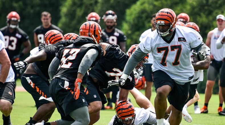 Bengals’ linebacker Preston Brown (52) prepares to meet offensive tackle Cordy Glenn (77) during a drill during organized team activities Tuesday, May 22, 2018, at the practice facility near Paul Brown Stadium in Cincinnati. OTAs continued on Tuesday. NICK GRAHAM/STAFF