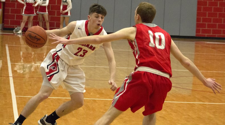 Cedarville’s Colby Cross is defended by Southeastern’s Bryce Grim during Cedarville’s 74-51 victory Friday on opening night in the Division IV sectional at Troy High School. Cross scored 21 points. Jeff Gilbert/CONTRIBUTED