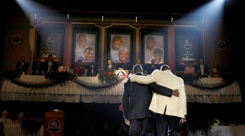 After receiving his blazer from his son Donald Carson, New York Giants' Harry Carson walks arm-in-arm with his son off stage during ceremonies at the Enshrinement Dinner in Canton, Ohio on Friday, August 4, 2006. (Louis DeLuca/Dallas Morning News/TNS)NO MAGAZINE SALES MANDATORY CREDIT; NO SALES; INTERNET USE BY TNS CONTRIBUTORS ONLY