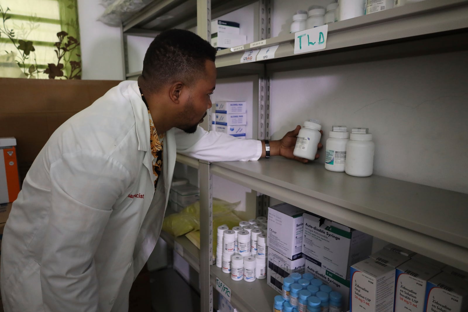Dr. Execuel Laguerre checks inventory in the room where medications are stored at the New Hope Hospital, in Plaine-du-Nord, Haiti, Wednesday, May 21, 2025. (AP Photo/Patrice Noel)