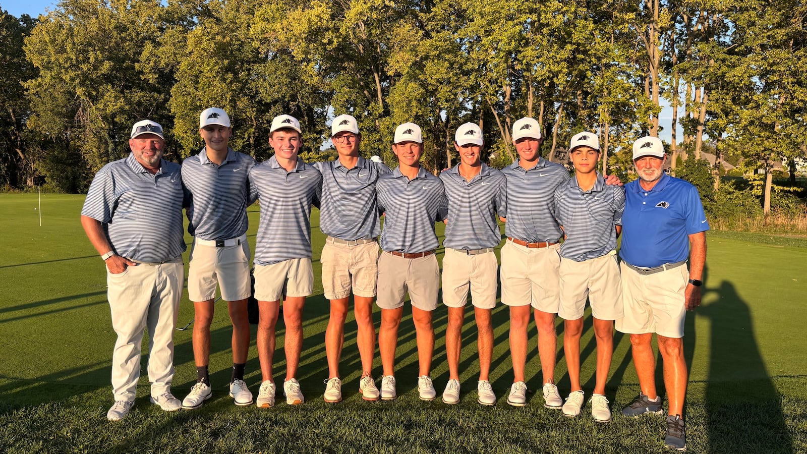 The Springboro boys golf team stands together after breaking the nine-hole school record with a team score of 130 from the back tees during a match against Centerville at Heatherwoode Golf Club. MATT COLE