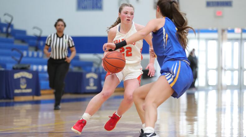 Cutline: Waynesville High School junior Isabella Cassoni drives past Mariemont's Kendall Spreen during their game on Saturday afternoon at Springfield High School. Cassoni scored 21 points as the Spartans won 33-29. Michael Cooper/CONTRIBUTED