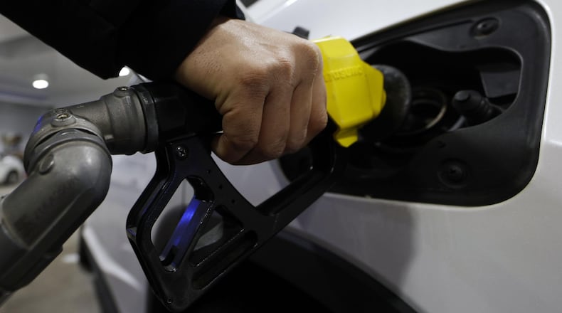 A customer fills up a fuel tank of a vehicle at a gas station in Tokyo, on March 12, 2026. (Suo Takekuma/Kyodo News via AP)