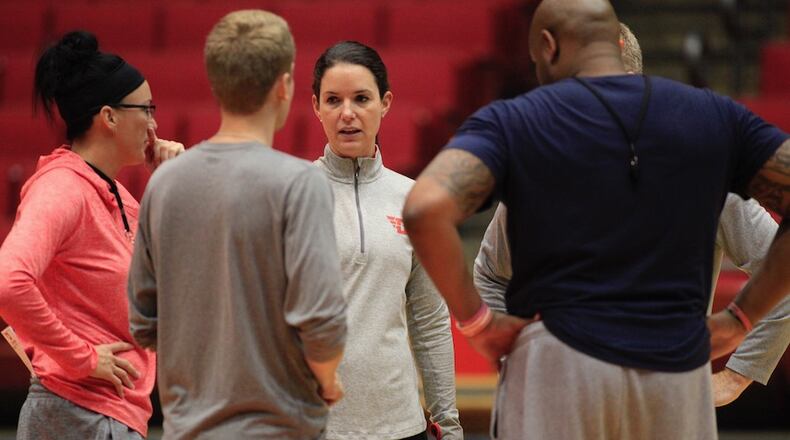 Dayton head coach Shauna Green talks to her staff during practice at UD Arena on Tuesday, Oct. 11, 2016. David Jablonski/Staff