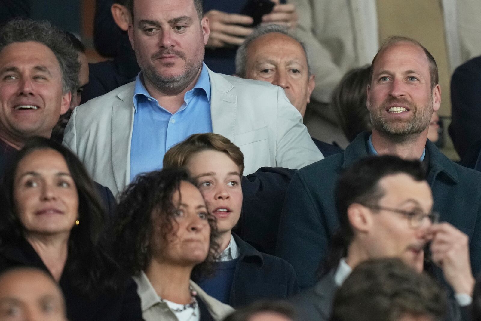 Britain's Prince William, right, with his eldest son Prince George on the stages during the Champions League quarterfinal first leg soccer match between Paris Saint-Germain and Aston Villa at Parc des Princes stadium in Paris, Wednesday, April 9, 2025. (AP Photo/Thibault Camus)