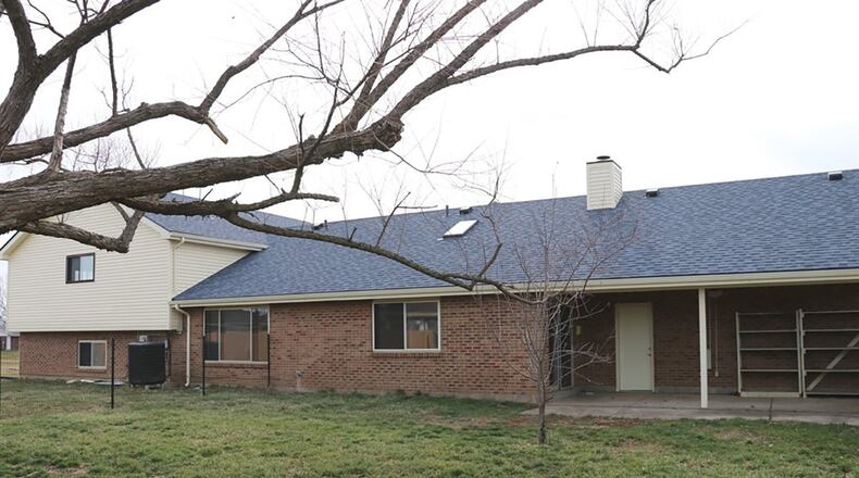 Sliding patio doors open off the family room, which has skylights, a wood-beam accented ceiling and a gas fireplace.