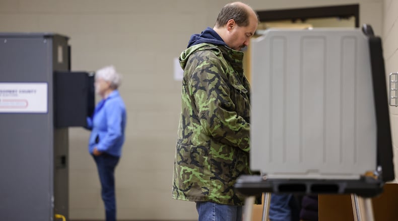 Voters at a polling location at New Season Ministry in Huber Heights contemplate issues on Tuesday, May 6. BRYANT BILLING / STAFF