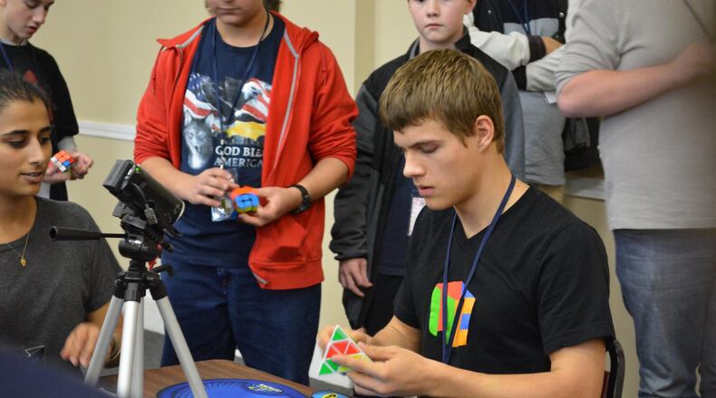Drew Brads, of Xenia, solves a 4x4 Rubik’s Cube at competition. CONTRIBUTED