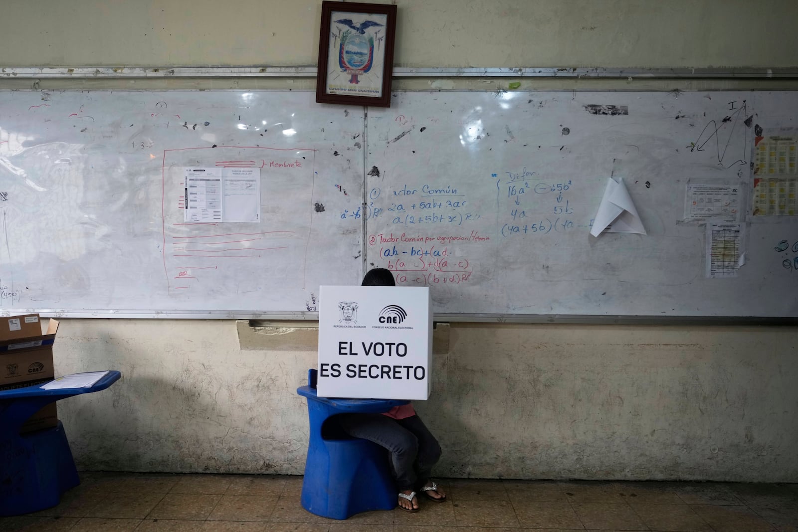A voter marks the ballot during the presidential election runoff in Olon, Ecuador, Sunday, April 13, 2025. (AP Photo/Fernando Vergara)