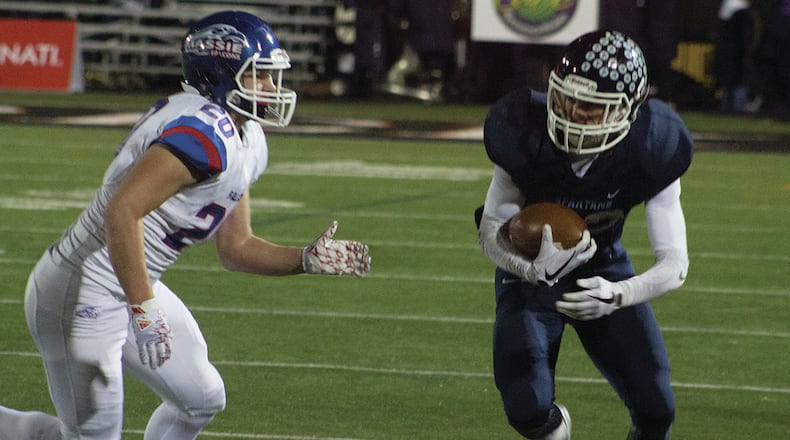 Valley View receiver PJ Varnadoe turns up field after a catch as Clinton-Massie’s Tyler Beam during Friday night’s playoff game at Beavercreek. JEFF GILBERT/CONTRIBUTED