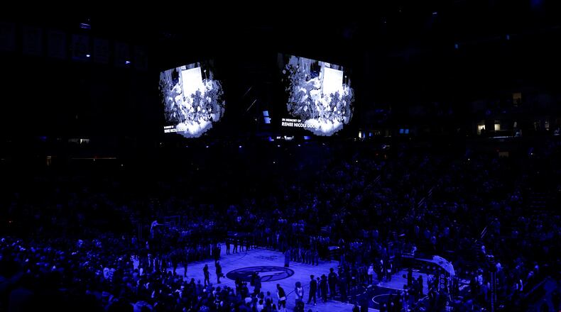 Minnesota Timberwolves and Cleveland Cavaliers players take part in a moment of silence for Renee Good, who was fatally shot by an ICE officer yesterday in Minneapolis, before an NBA basketball game, Thursday, Jan. 8, 2026, in Minneapolis. (AP Photo/Matt Krohn)