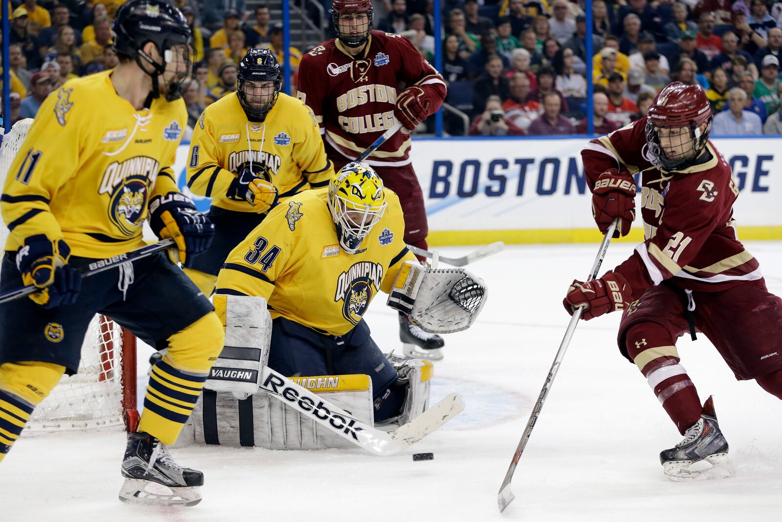 FILE - Quinnipiac goalie Michael Garteig (34) makes the save on a shot by Boston College forward Matthew Gaudreau (21) during the first period of an NCAA Frozen Four semifinal NCAA college hockey game, April 7, 2016, in Tampa, Fla. (AP Photo/Chris O'Meara, File)