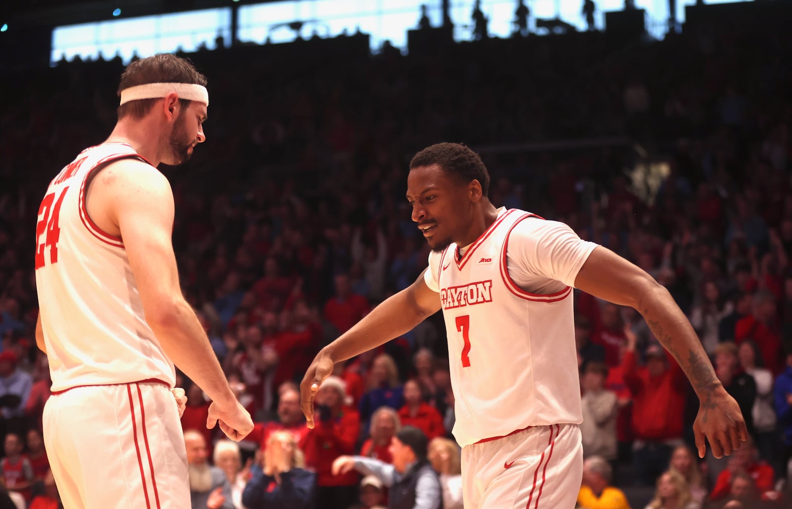 Dayton's Keonte Jones, right, slaps hands with Jacob Conner after scoring late in the second half against Liberty on Saturday, Dec. 20, 2025, at UD Arena. David Jablonski/Staff
