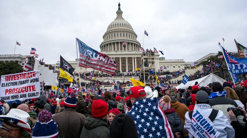 FILE - Rioters loyal to President Donald Trump rally at the U.S. Capitol in Washington on Jan. 6, 2021. The FBI arrested three Florida residents on Saturday, Jan. 6, 2024, the third anniversary of their alleged attack on Capitol police officers during the Jan. 6, 2021, insurrection. (AP Photo/Jose Luis Magana, File)