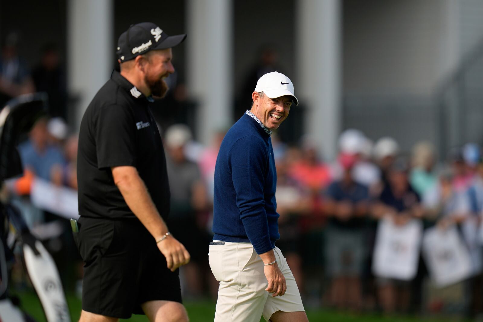 Rory McIlroy, of Northern Ireland, right, laughs with Shane Lowry, of Ireland, as they walk on the 18th green during a practice round ahead of the U.S. Open golf tournament at Oakmont Country Club Tuesday, June 10, 2025, in Oakmont, Pa. (AP Photo/Seth Wenig)