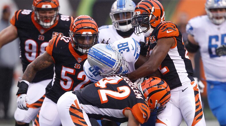CINCINNATI, OH - DECEMBER 24: William Jackson #22, Clayton Fejedelem #42 and Brandon Bell #52 of the Cincinnati Bengals tackle Tion Green #38 of the Detroit Lions during the second half at Paul Brown Stadium on December 24, 2017 in Cincinnati, Ohio. (Photo by Joe Robbins/Getty Images)