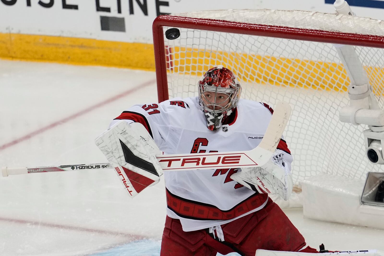 Carolina Hurricanes goaltender Frederik Andersen deflects a shot during the first period of Game 4 of an NHL hockey first-round series against the New Jersey Devils, Sunday, April 27, 2025, in Newark, N.J. (AP Photo/Seth Wenig)