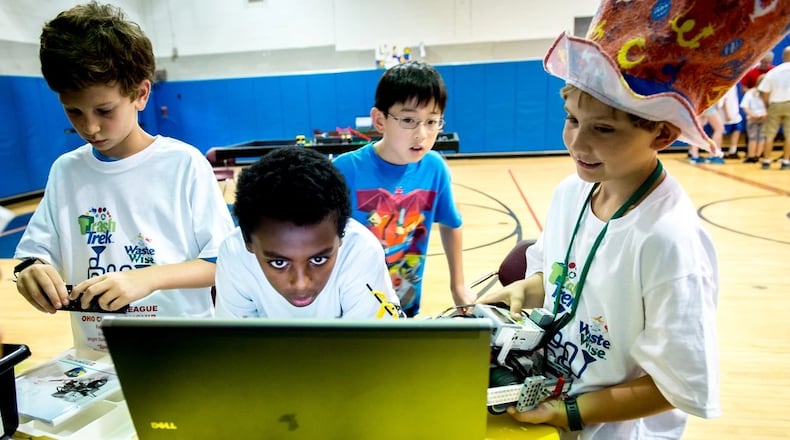 Zachary Shockey, 10, Samson Scheie, 12, Lance Zhang, 10, and Samuel Snowden, 9, program their robot during a First Lego League tournament at the DoD Starbase building near the Air Force Research Laboratory at Wright Patterson Air Force Base in July 2016. (U.S. Air Force photo by J.M. Eddins Jr.)