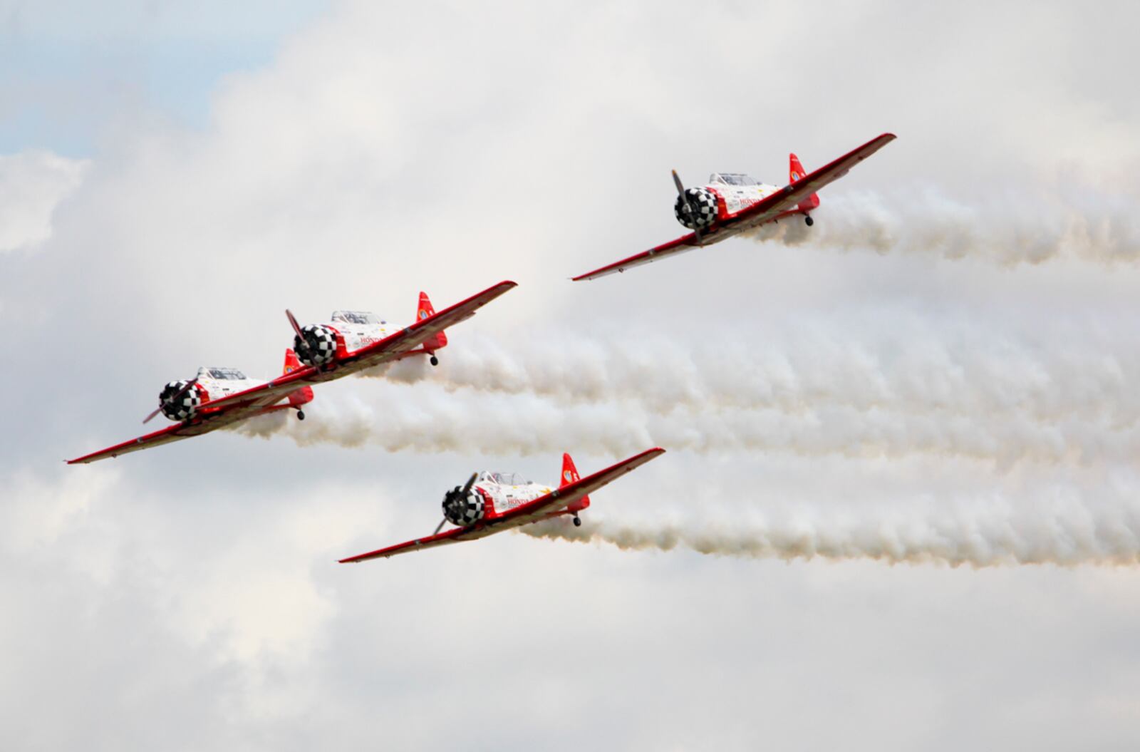 The AeroShell Formation Aerobatic Team performs during the Vectren Dayton Air Show held at the Dayton International Airport, Sunday, June 29, 2014. GREG LYNCH / STAFF