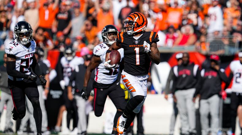 Cincinnati Bengals wide receiver Ja'Marr Chase (1) runs for a touchdown after a catch against the Atlanta Falcons in the first half of an NFL football game in Cincinnati, Sunday, Oct. 23, 2022. (AP Photo/Jeff Dean)