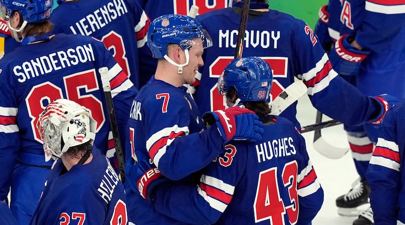 United States' Quinn Hughes (43) celebrates with Brady Tkachuk (7) after Hughes scored the winning goal in overtime to beat Sweden in a men's ice hockey quarterfinal game at the 2026 Winter Olympics, in Milan, Italy, Wednesday, Feb. 18, 2026. (AP Photo/Hassan Ammar)