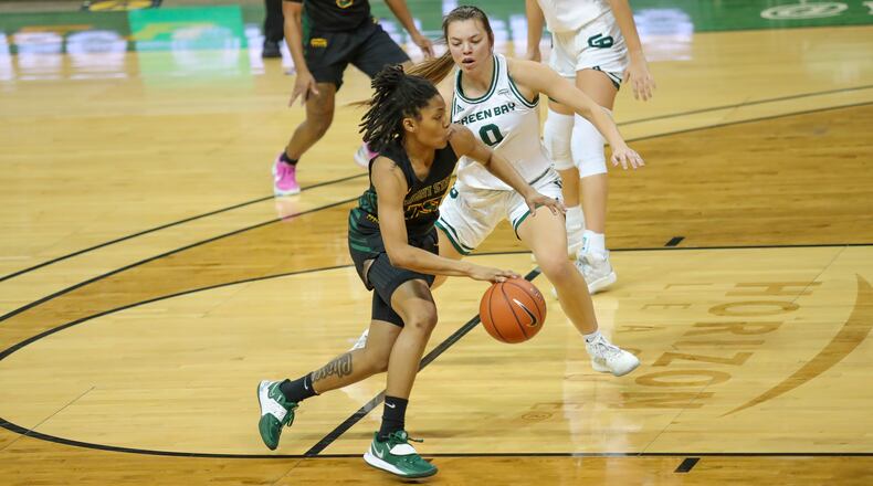 Cutline: Wright State University junior Angel Baker drives past Green Bay's Hailey Oskey during their game on Saturday, Feb. 20 at the Ervin J. Nutter Center in Fairborn. Baker scored a game-high 24 points for the Raiders. Michael Cooper/CONTRIBUTED