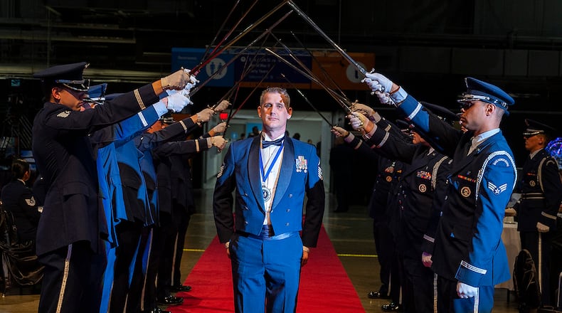 Master Sgt. Jeramie Proctor, Air Force Sustainment Center, pauses after walking through the Honor Guard cordon during the Air Force Materiel Command Annual Excellence Awards Banquet on March 23 in the National Museum of the U.S. Air Force. Proctor was nominated for the command’s Senior NCO of the Year Award. U.S. AIR FORCE PHOTO/R.J. ORIEZ