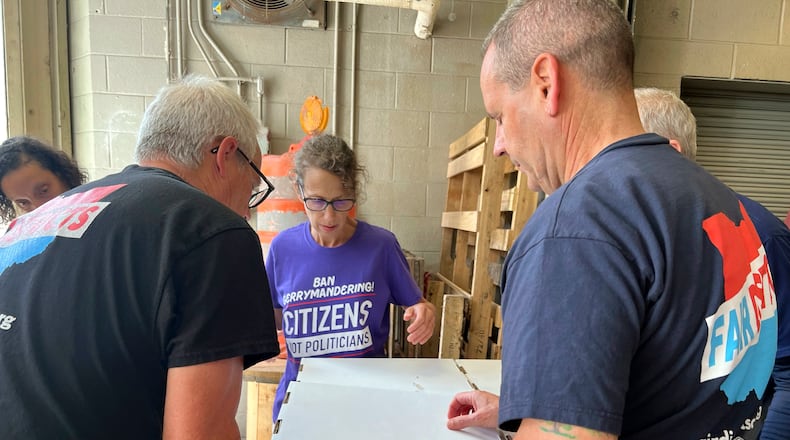 Volunteers with Citizens Not Politicians load boxes of signed petitions to Secretary of State Frank LaRose's office on Monday, July 1, 2024, in Columbus, Ohio. Backers of a proposal to change Ohio's troubled political mapmaking system delivered hundreds of thousands of signatures on Monday as they work to qualify for the statewide ballot this fall. (AP Photo/Patrick Orsagos)