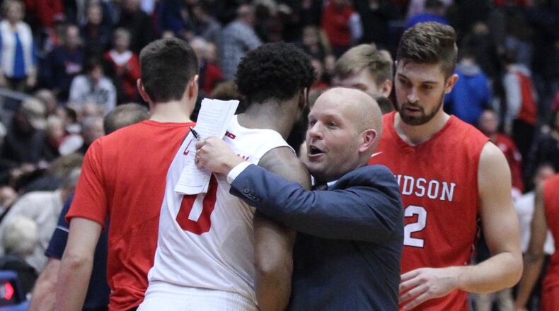 Davidson’s Kevin Kuwik hugs Dayton’s Josh Cunningham after a game on Tuesday, Jan. 23, 2018, at UD Arena. David Jablonski/Staff