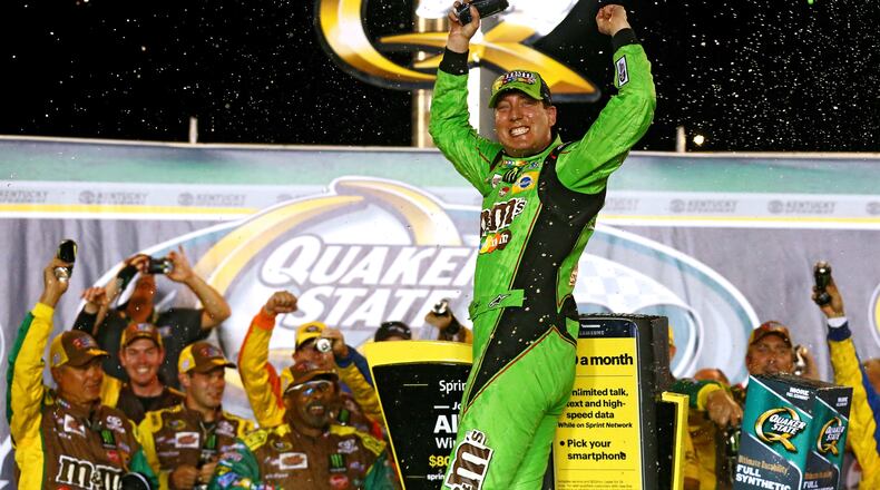 SPARTA, KY - JULY 11: Kyle Busch, driver of the #18 M&M’s Crispy Toyota, celebrates in Victory Lane after winning the NASCAR Sprint Cup Series Quaker State 400 presented by Advance Auto Parts at Kentucky Speedway on July 11, 2015 in Sparta, Kentucky. (Photo by Sarah Crabill/Getty Images)